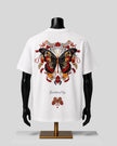 White short-sleeve T-shirt displayed on a black mannequin torso, showing a large colorful butterfly graphic on the back with floral details and the word 'Butterfly' printed below.