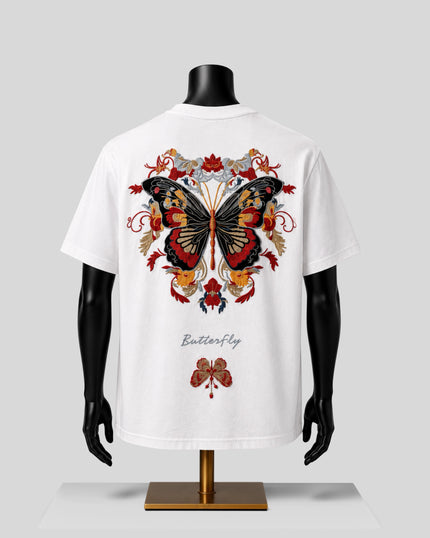 White short-sleeve T-shirt displayed on a black mannequin torso, showing a large colorful butterfly graphic on the back with floral details and the word 'Butterfly' printed below.