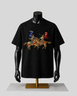 A black short-sleeve t-shirt displayed on a black mannequin torso with a gold stand, featuring a graphic print of two medieval knights on horseback with blue and red banners against a light gray background.