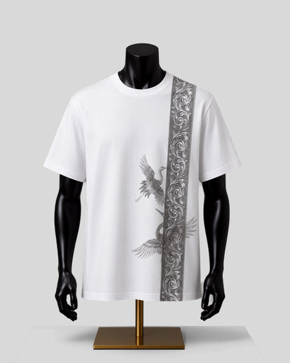 White short-sleeve T-shirt displayed on a black mannequin torso and arms, featuring a vertical gray ornamental panel on the right side and a gray crane graphic on the front, set against a light gray studio background.