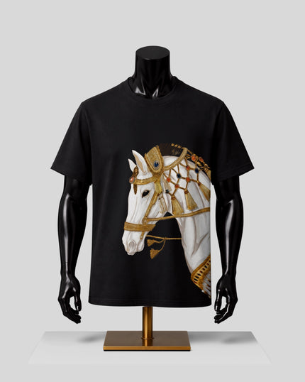 A black short-sleeve T-shirt displayed on a black mannequin torso with a gold stand, featuring a large graphic print of a white horse wearing ornate gold harness details on the front.