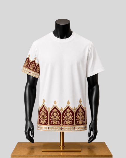 A white short-sleeve t-shirt displayed on a black mannequin torso, featuring a decorative border pattern in burgundy and gold along the hem and one sleeve, set against a light gray background.