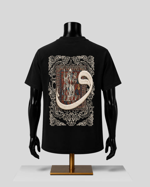 A black short-sleeve T-shirt displayed on a black mannequin torso with a gold stand, shown from the back. The shirt features a large medieval-style illuminated manuscript illustration with a prominent cream-colored snake coiling through the design.