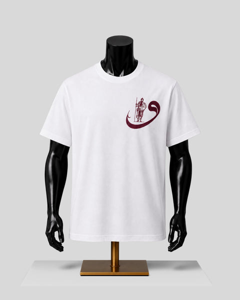 A white short-sleeve crewneck t-shirt displayed on a black mannequin torso with a gold stand, featuring a dark red graphic on the left chest of a figure holding a staff inside a curved ribbon-like shape.
