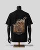 A black short-sleeve T-shirt displayed on a black mannequin torso, showing the back side with a large square graphic print in brown and beige tones. The graphic includes Arabic calligraphy and the text 'everything, in time' and 'THE POLLUR'.