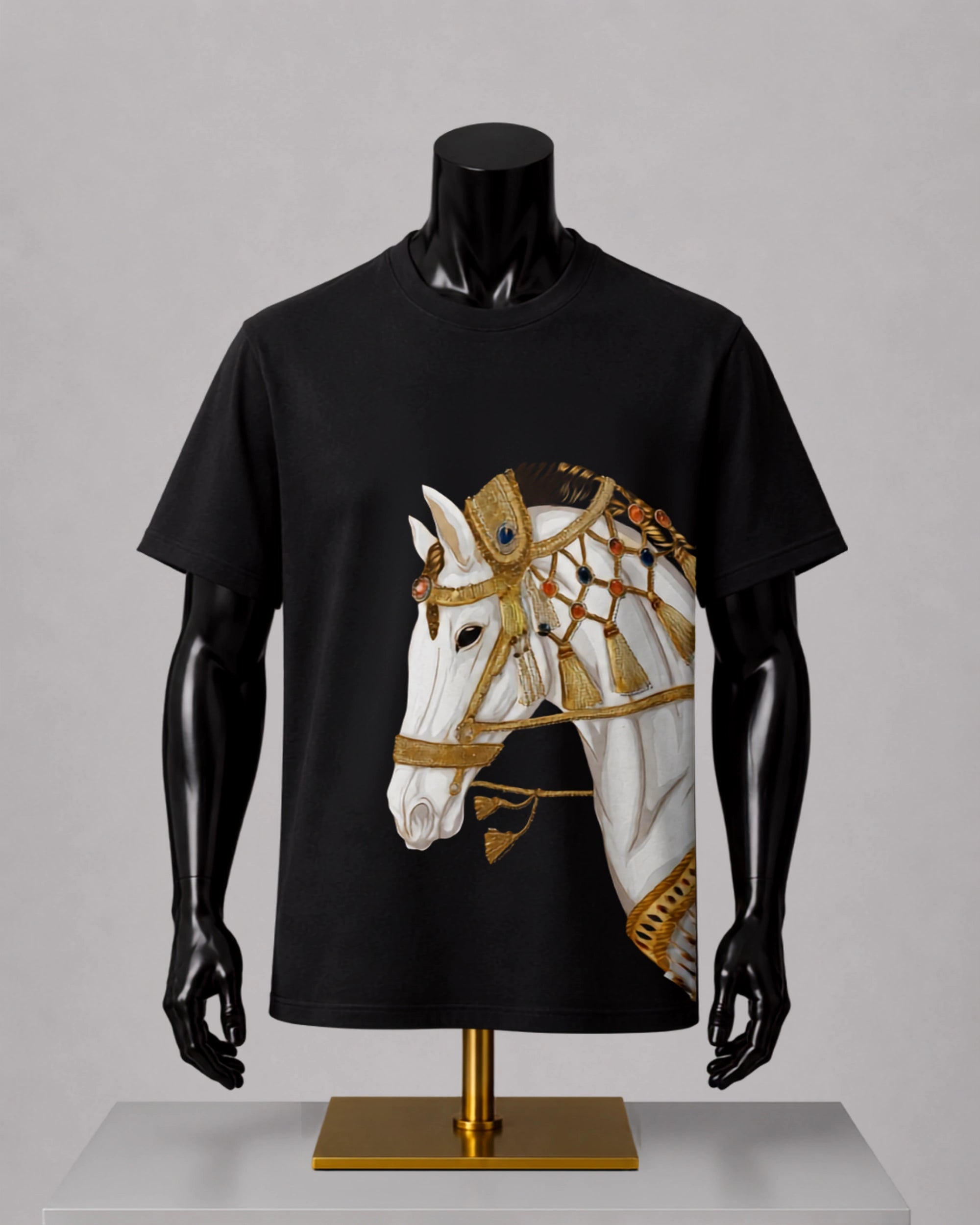 A black short-sleeve t-shirt displayed on a black mannequin torso with a gold stand, featuring a large graphic print of a white horse wearing ornate gold and brown decorative armor on the front.