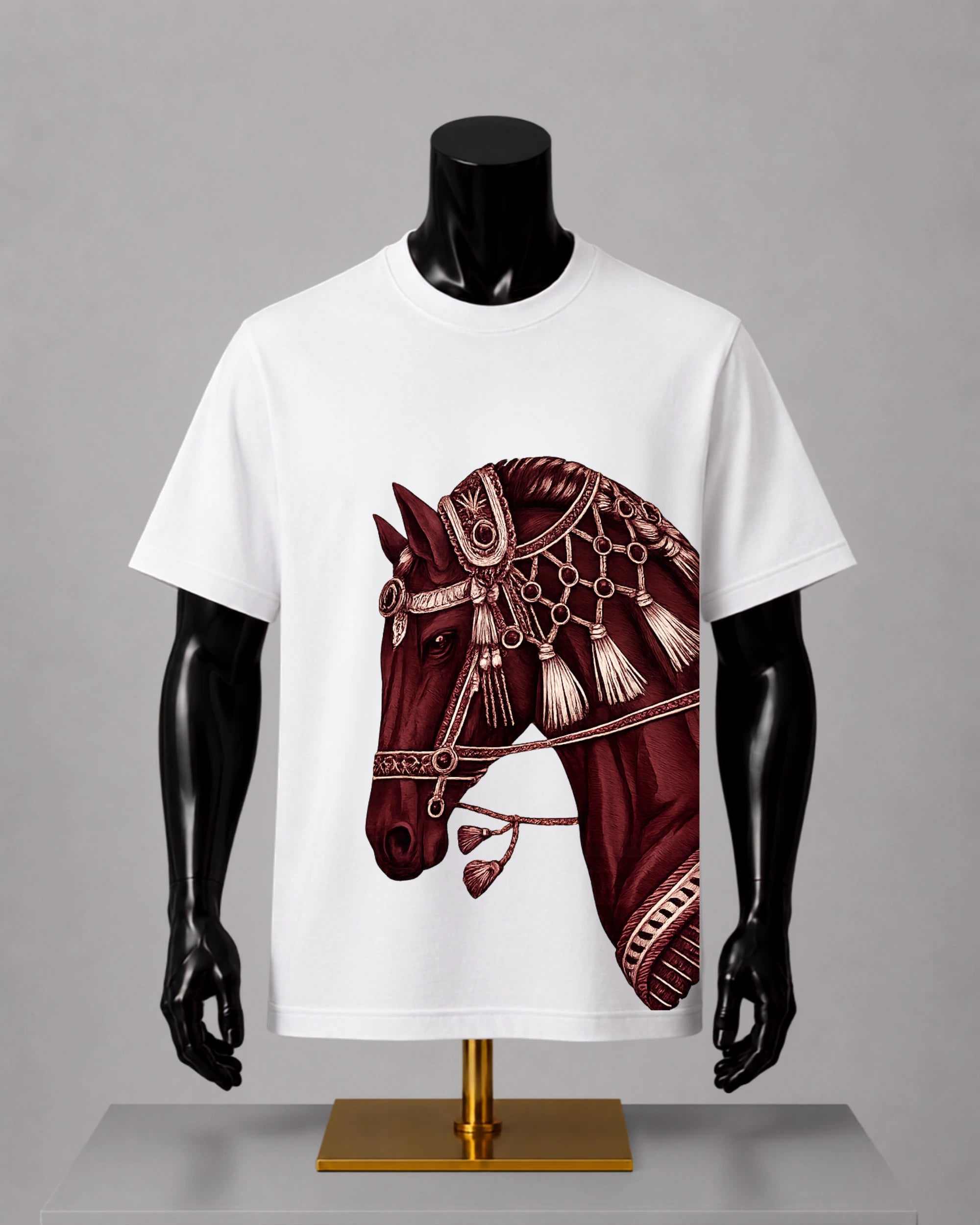 White short-sleeve crewneck T-shirt displayed on a black mannequin torso with arms, featuring a large graphic print of an ornate dark red horse head with beige decorative details on the front.
