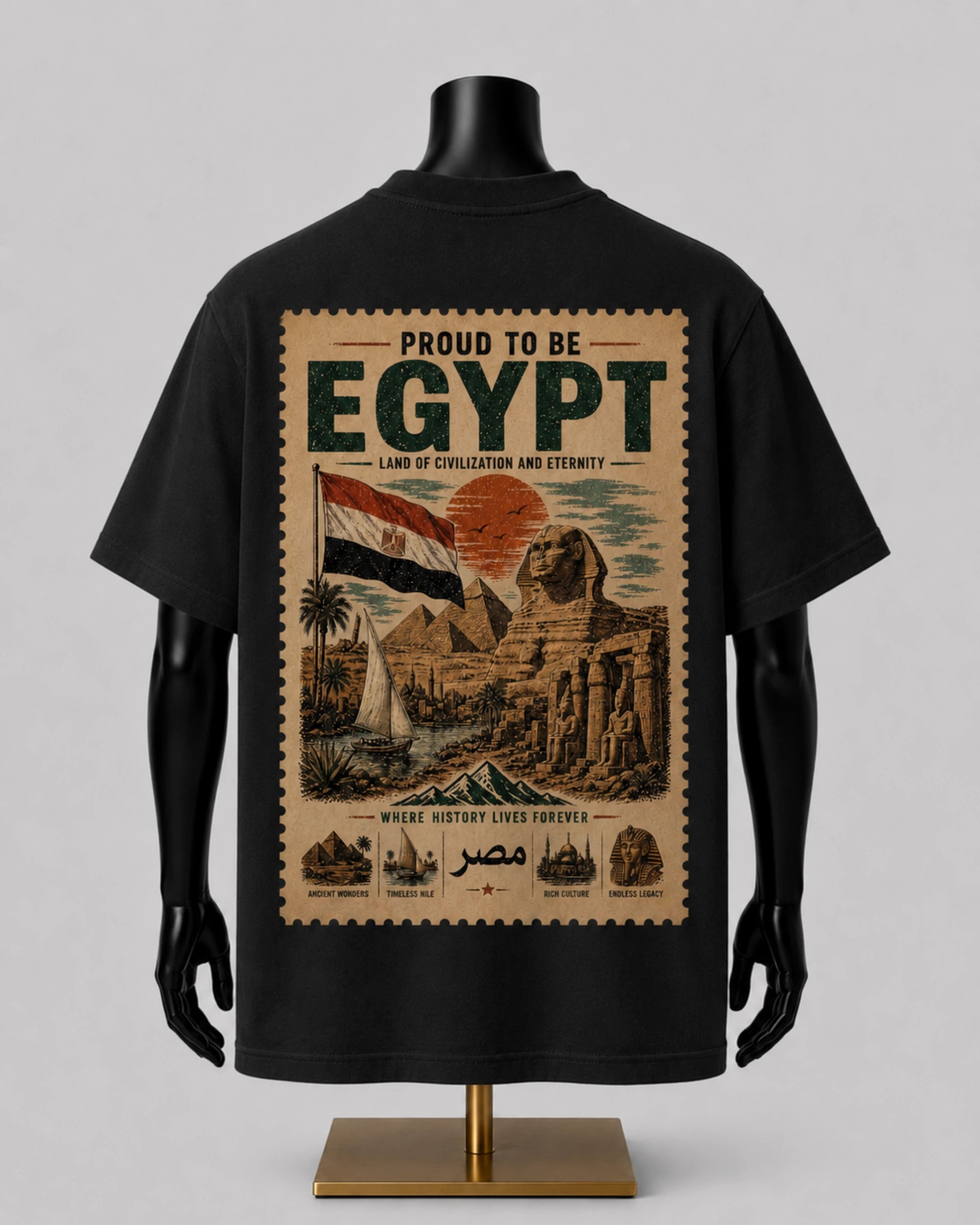 A black short-sleeve T-shirt displayed on a black mannequin torso with a large vintage-style Egypt graphic on the back. The print features the words 'PROUD TO BE EGYPT,' an Egyptian flag, pyramids, the Sphinx, a sailboat, and smaller illustrations along the bottom.