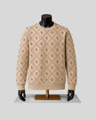 A beige crewneck sweater with a repeating brown interlocking 'R' monogram pattern, displayed on a black mannequin with black gloves and a gold stand against a light gray background.