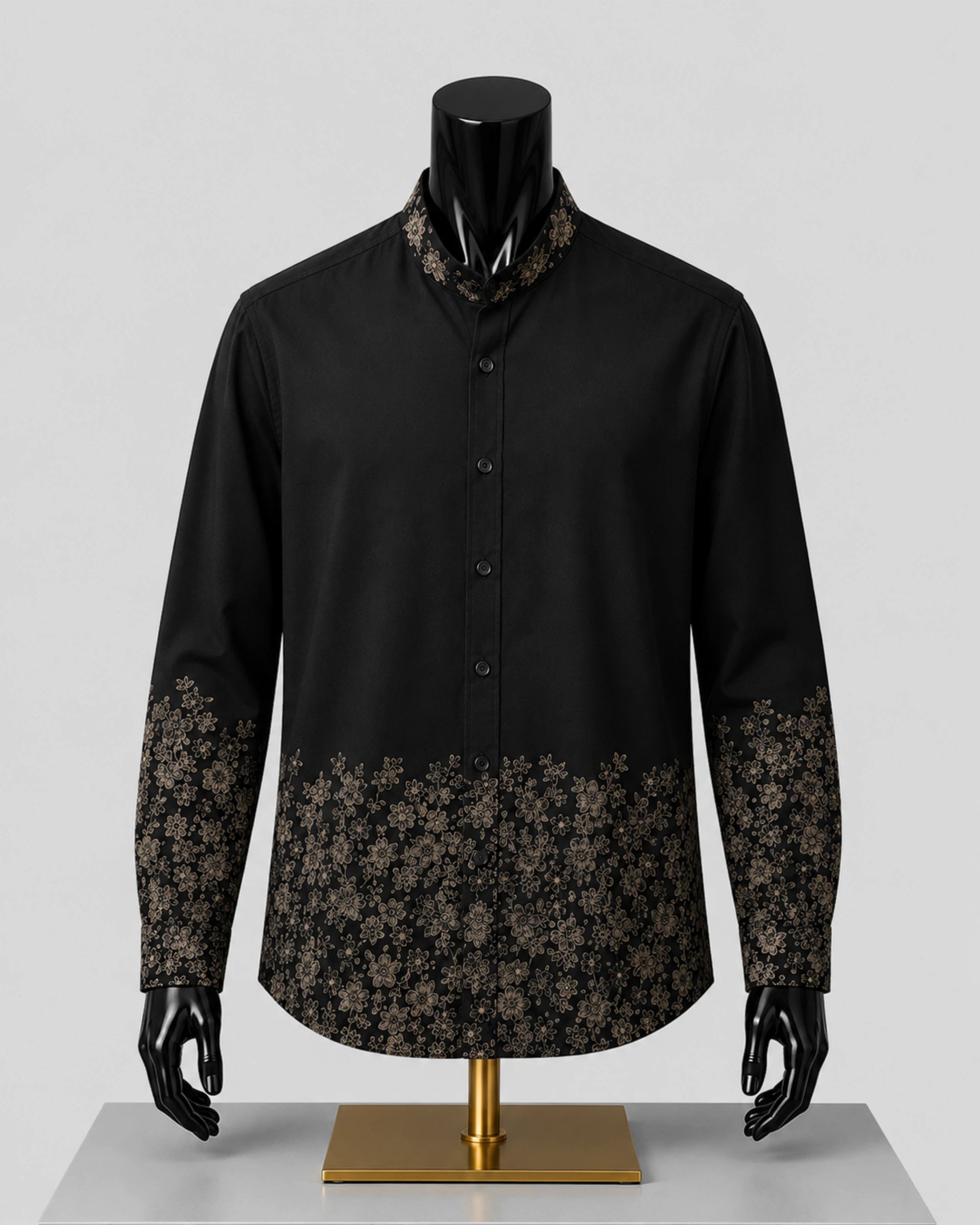 A black long-sleeve button-up shirt displayed on a black mannequin with a gold stand, featuring a patterned collar and floral lace-like cuffs in a dark brown and black design.