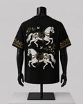 Black short-sleeve T-shirt displayed on a black mannequin torso, showing a large back print of two white horses with gold decorative details and small bird motifs.
