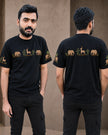 A man modeling a black short-sleeve t-shirt with a horizontal graphic print of safari animals (elephants, giraffes, zebras) and plants in tan and green, shown from both the front and back views against a neutral beige wall.