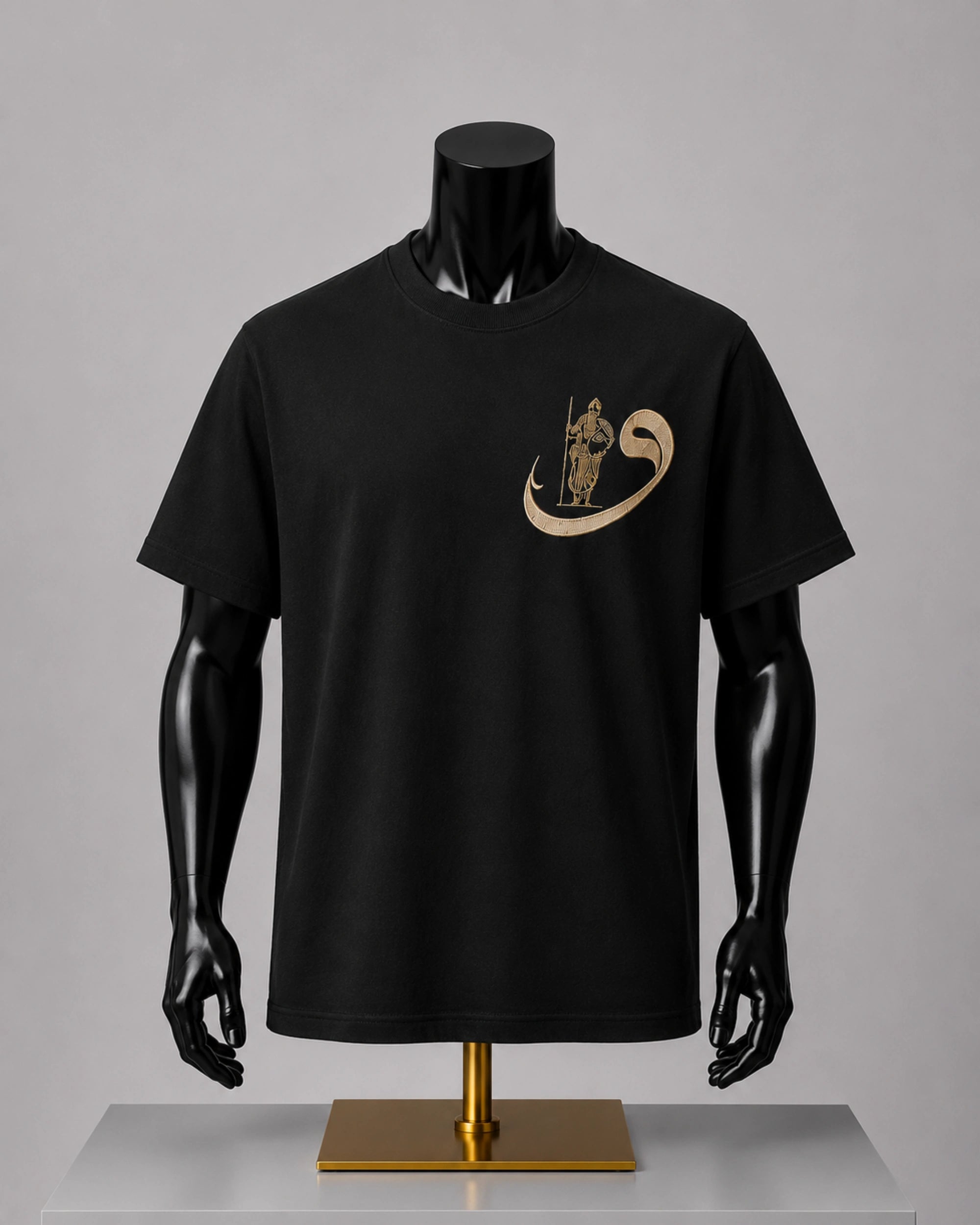 A black short-sleeve crewneck t-shirt displayed on a black mannequin torso with a gold chest graphic, set against a neutral gray background.