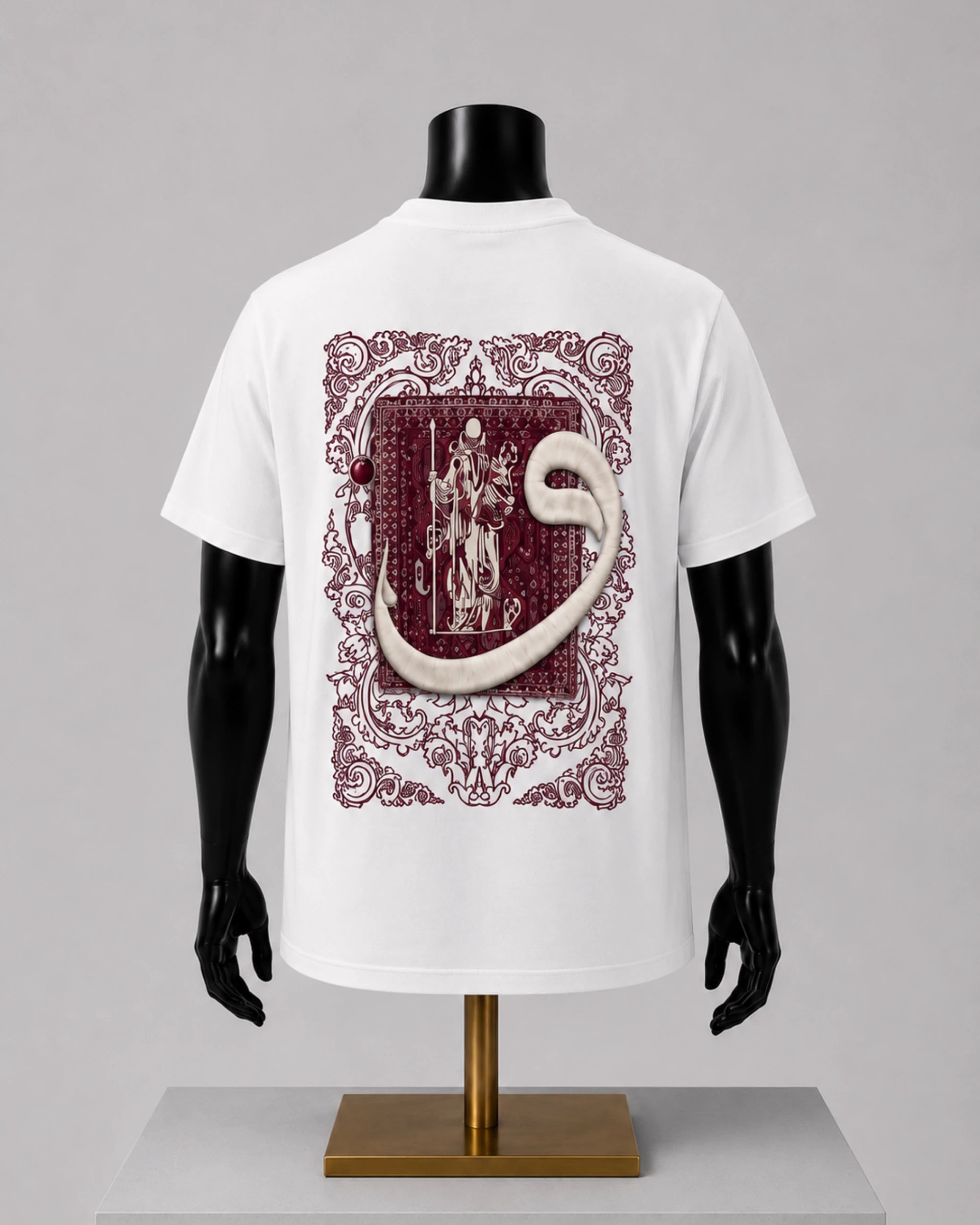 White short-sleeve T-shirt displayed on a black mannequin torso with a large vintage-style heraldic graphic on the back in burgundy and cream, set against a light gray studio background.